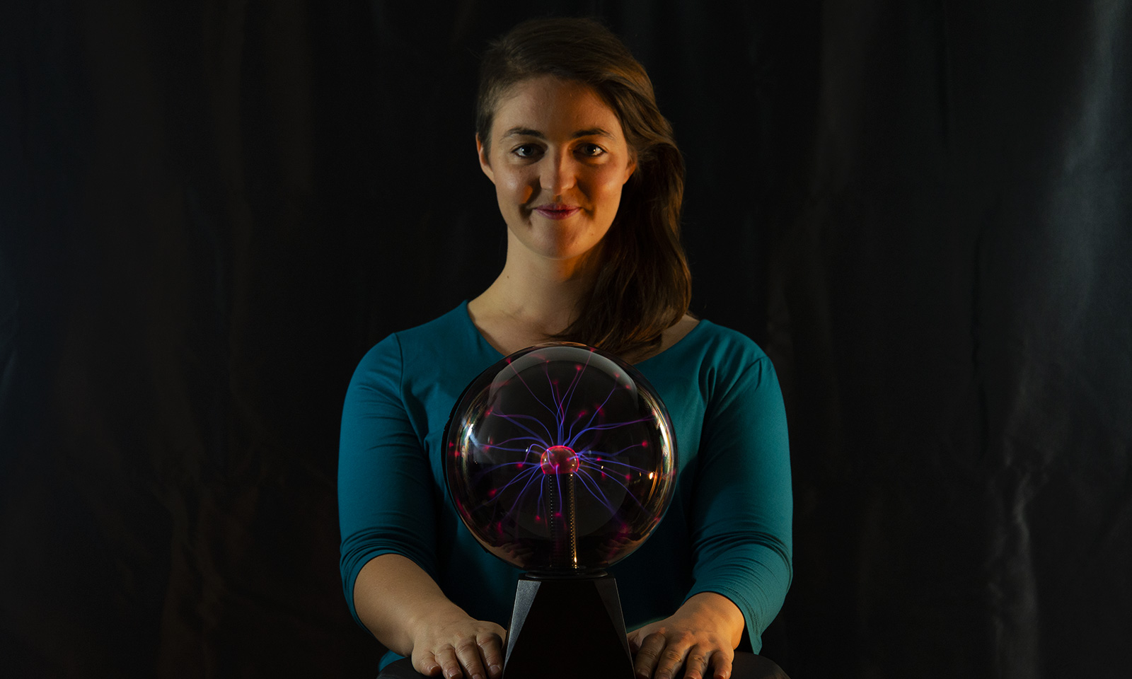 Natasha stands over a glowing plasma ball.